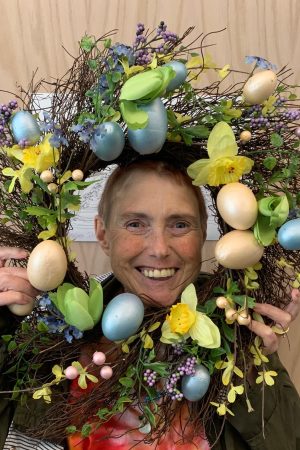 Woman smiling with wreath over head