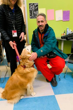 Man petting Healing Partners dog