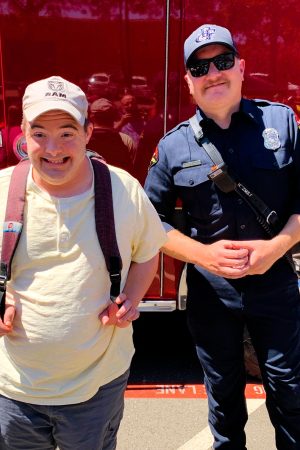 Man standing next to fireman